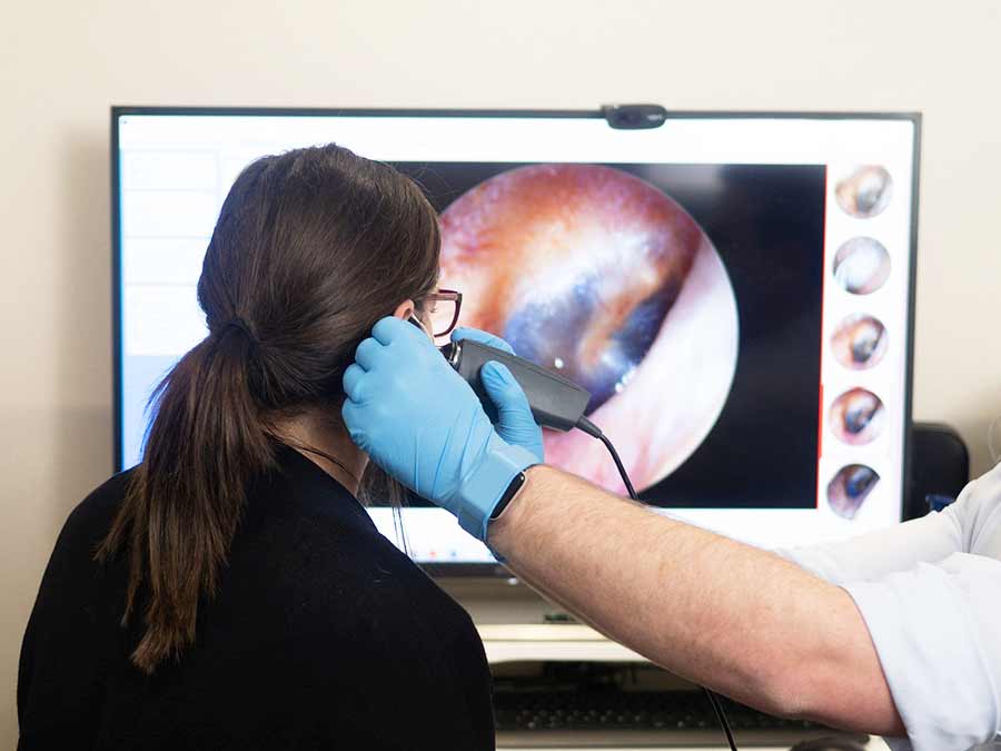 A video otoscope being used to examine hearing health at Amplify Hearing